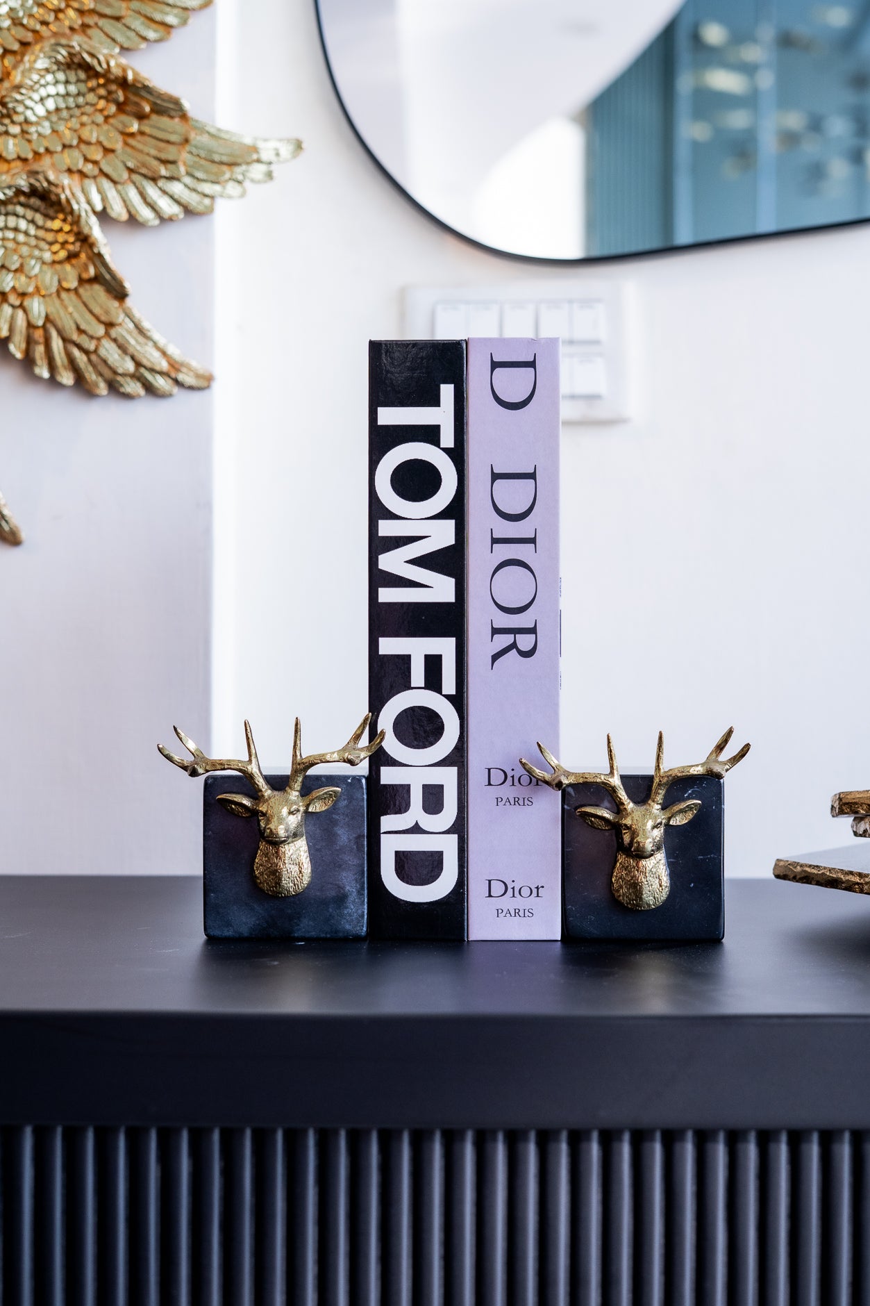 Tom Ford and Dior products on a shelf with decorative elements