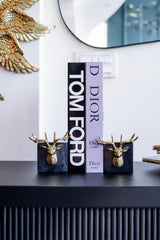 Tom Ford and Dior products on a shelf with decorative elements