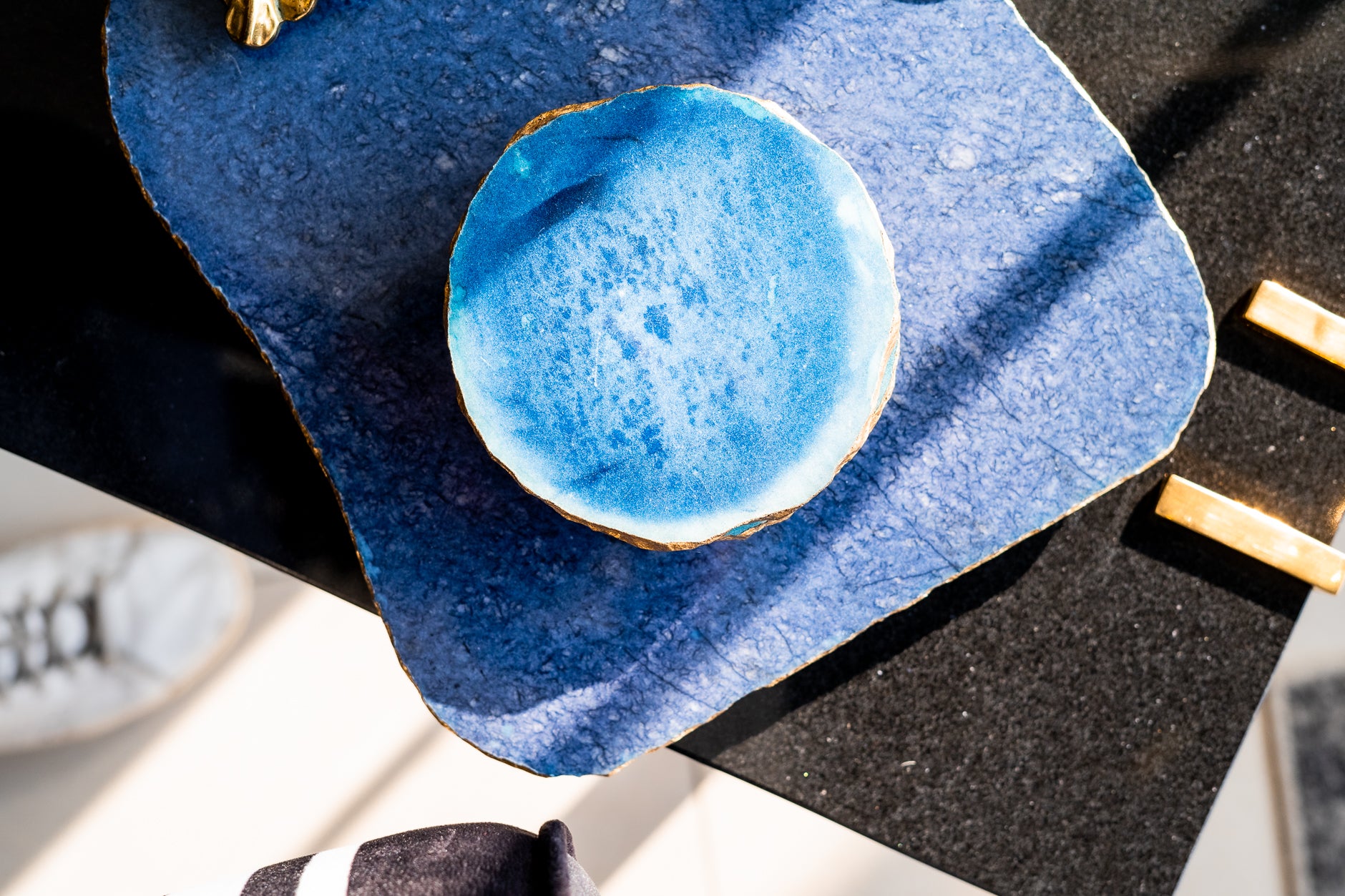 Blue ceramic plate with a textured surface on a dark surface