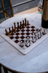 Chessboard with pieces on a marble table