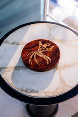 Wooden coaster with a design on a marble surface